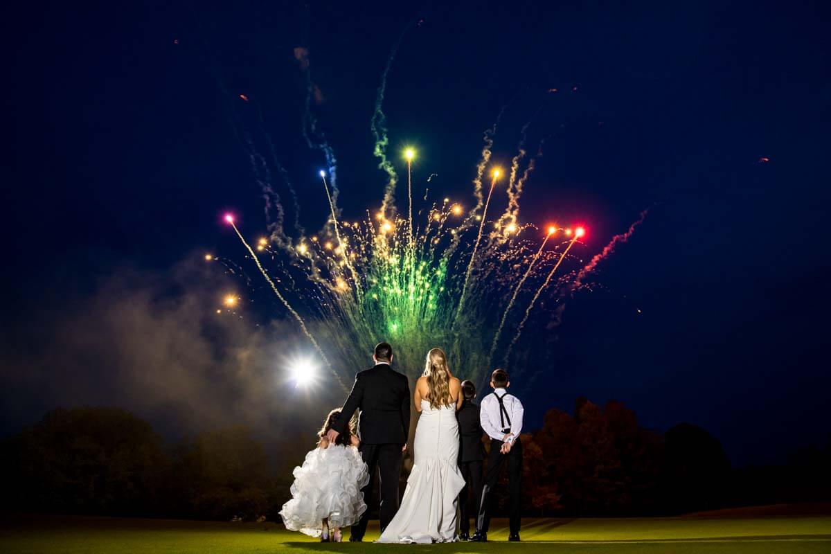 Wedding Couple watching fireworks at their reception