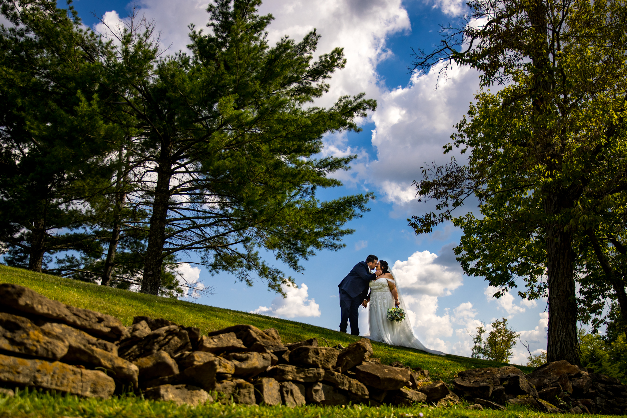 Summer wedding couple kiss at Broken Arrow Farm