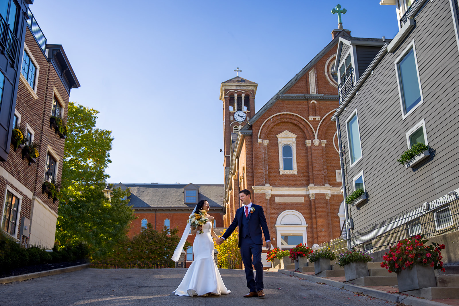 Bride and Groom walking in front of The Monastery Event Center in Mount Adams