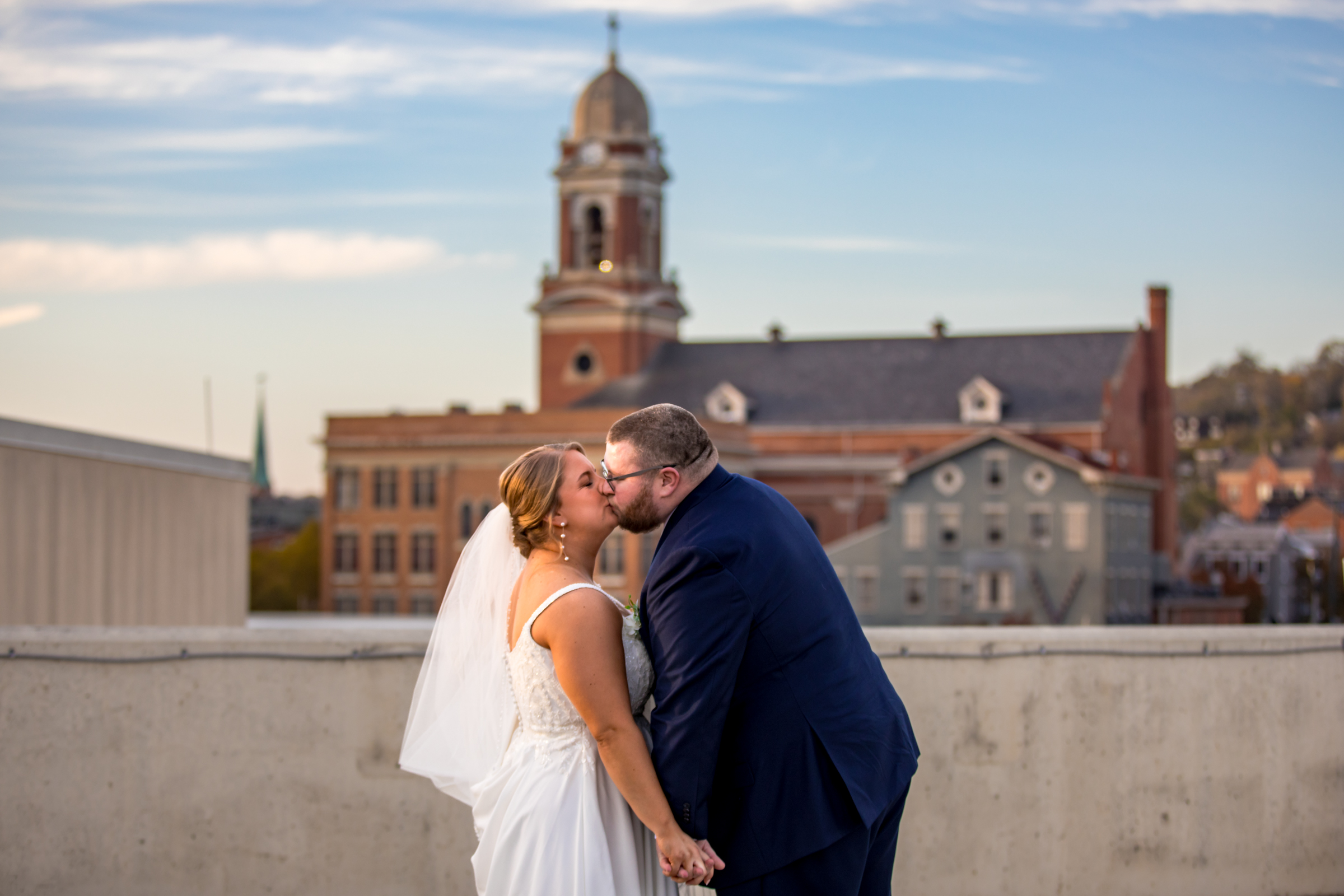 Wedding couple kiss in front of Bell Event Centre